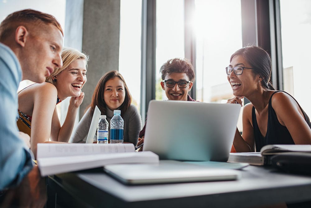 Group of learners studying together around a desk