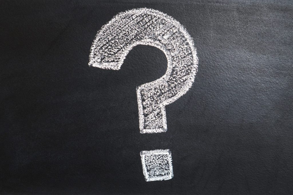 Question mark on a chalkboard, directing you to our FAQ page where you can contact us with any questions you may have
