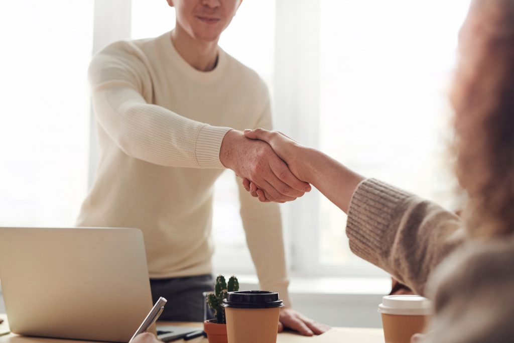 Employer shaking the hand of a potential traineeship learner after an interview