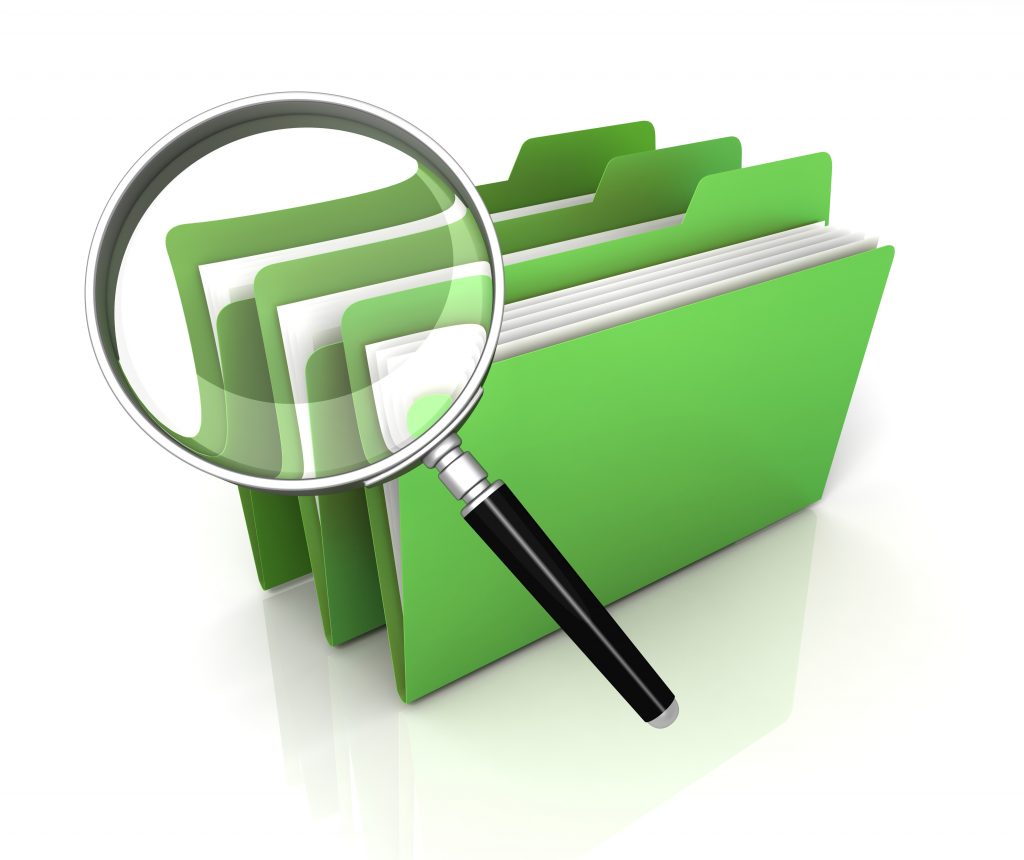 Magnifying glass focusing on green folders